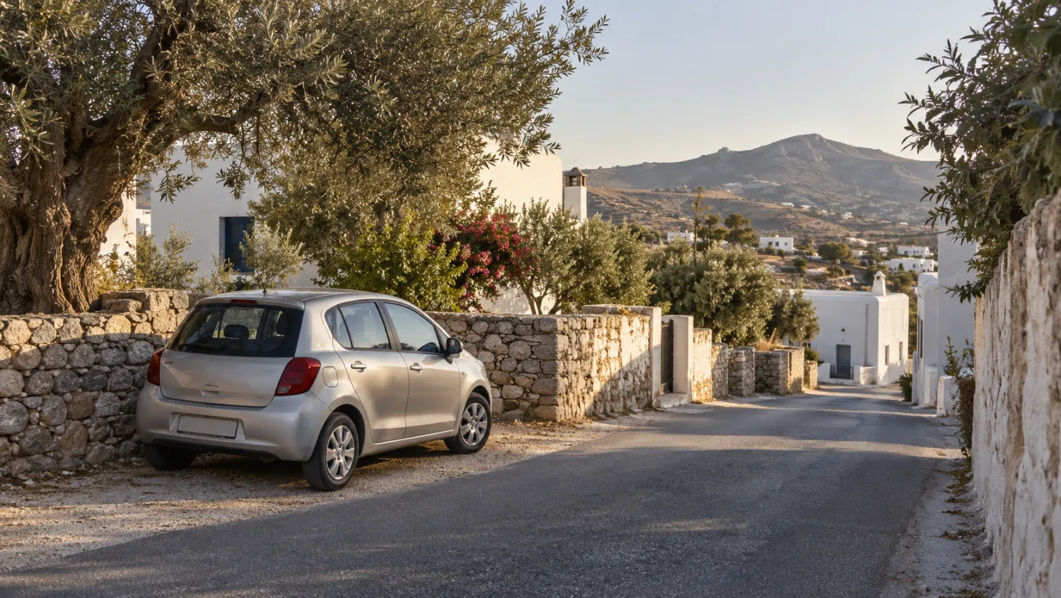 Car hire Antimachia illustration: silver compact car parked by stone walls on a village lane